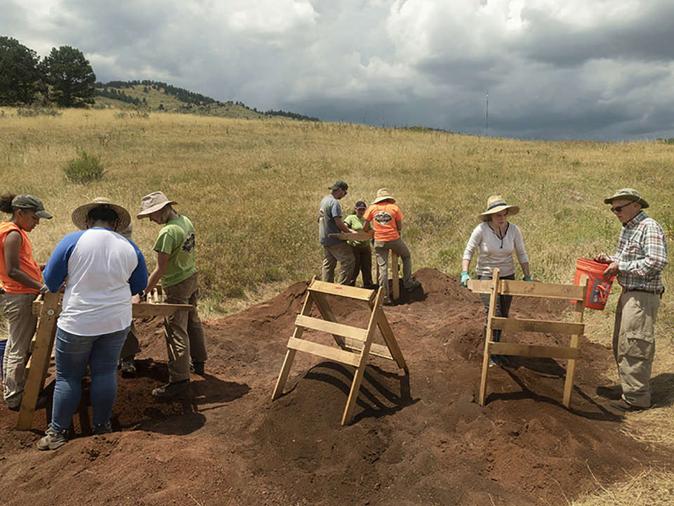Three screening areas are set up with various volunteers working at the Magic Mountain site