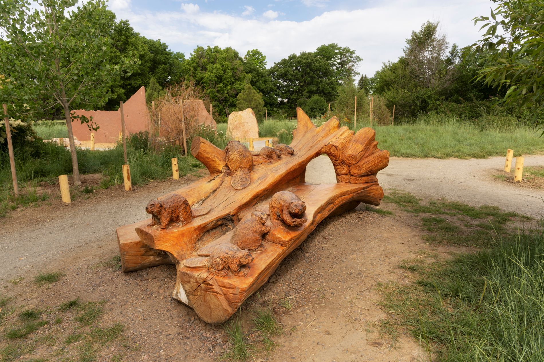 a bench shaped like a beaver dam — complete with a tunnel carved through the middle that children can slip through — was made by artist Faye Braaten, also known as “ChainsawMama.” (Photo/ Rick Wicker)