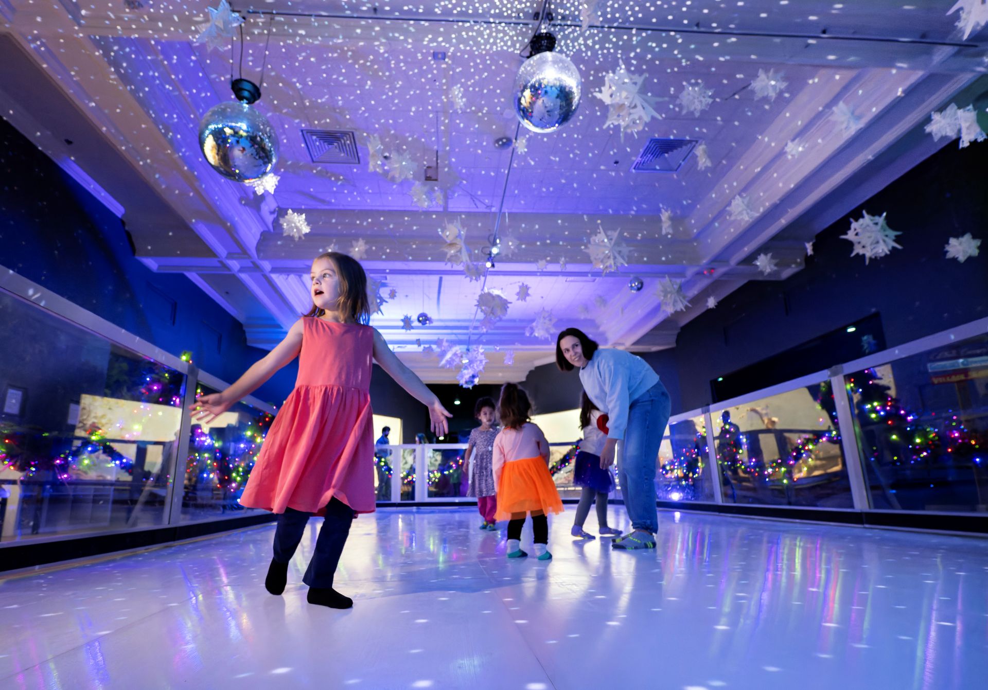 Families slip and slide around the ice-less skating experience in Magical Winter Nights. (Photo/ Rick Wicker)