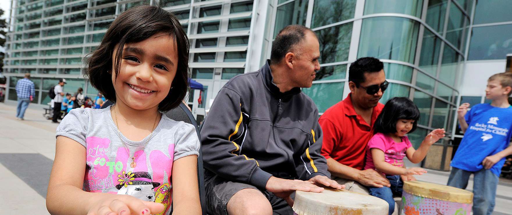 People sitting outside, child in the forefront 