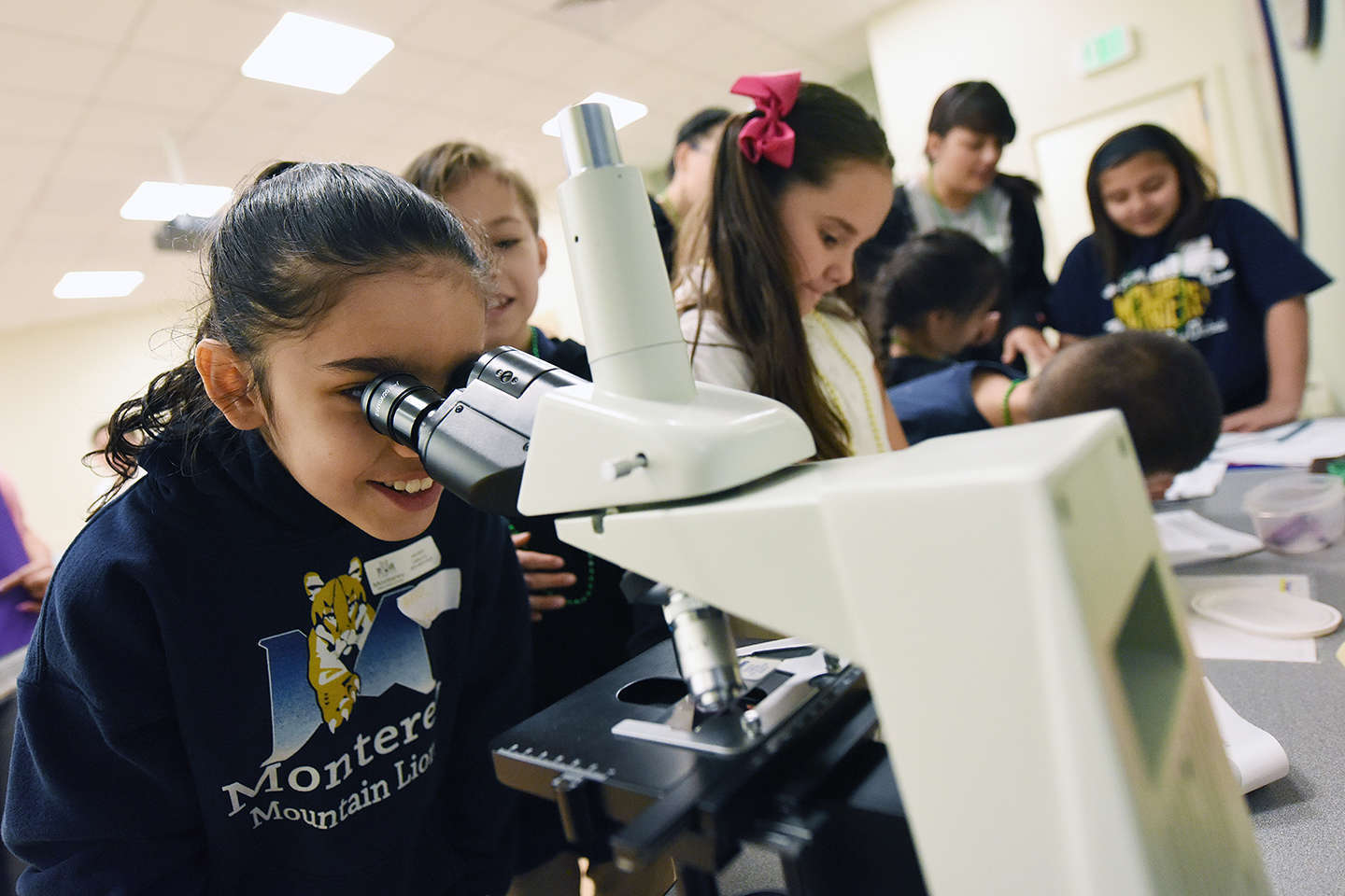 Children look into a microscope