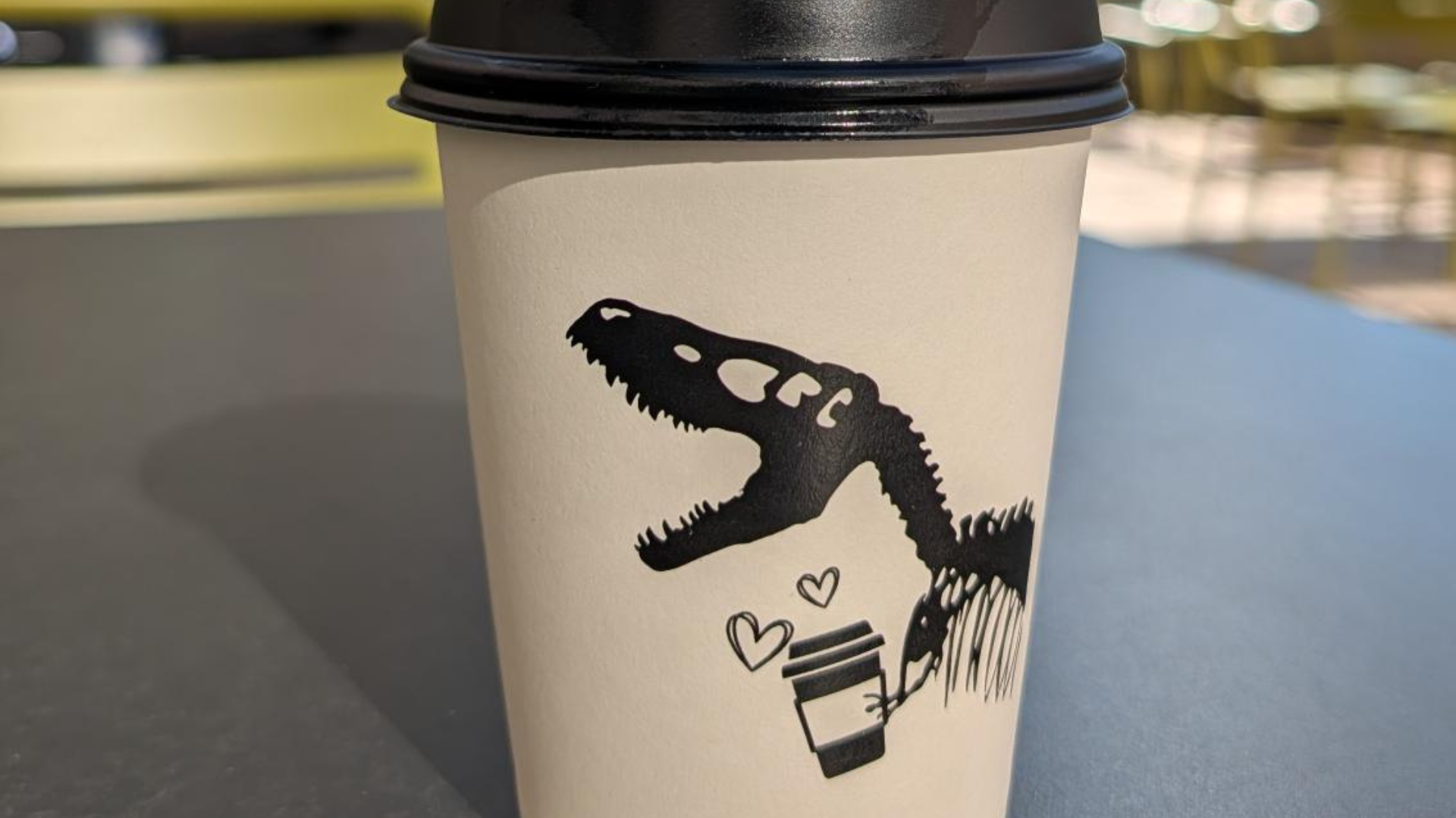 Coffee cup sitting on table on Plaza