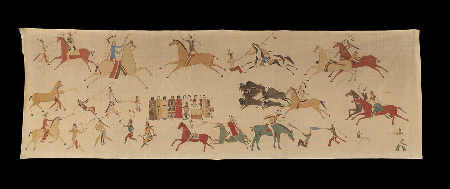 Large brown object with drawings of Native American scenes on a black background