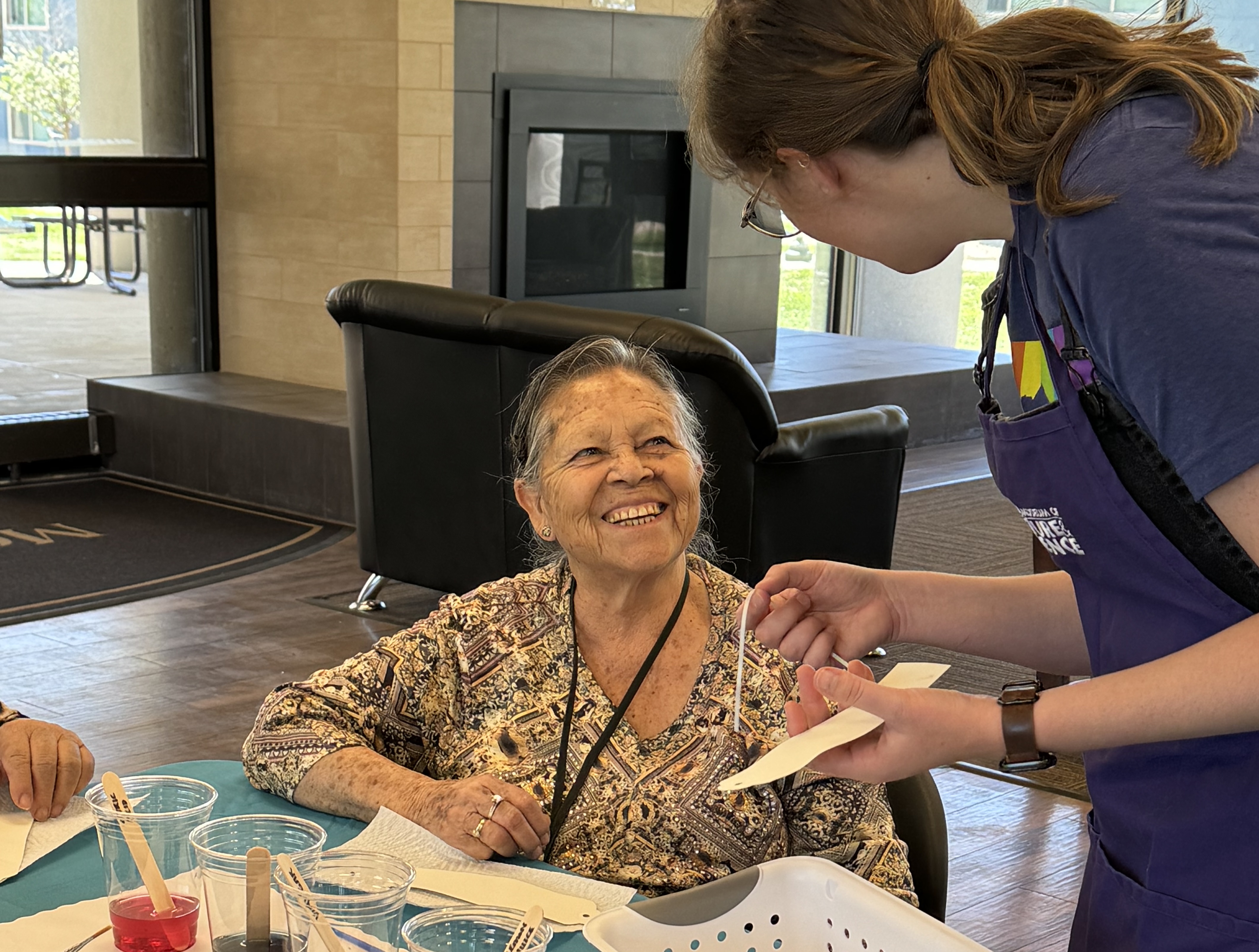 A program participant shares a smile with Program Coordinator Kelsi Cowan in the Creative Aging test program "Wild Colors and Natural Dyes" in July, 2024. (Photo/ Veronica Byrne)