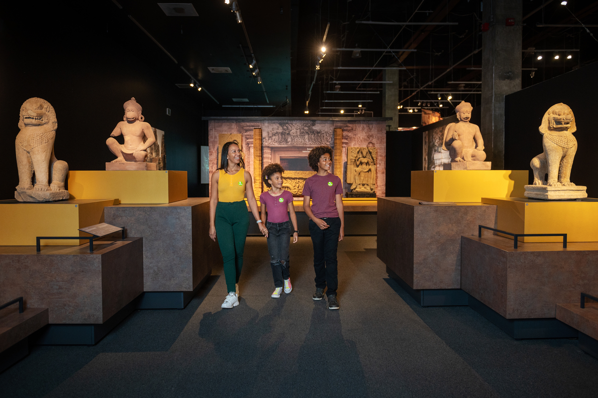 family walking through "Angkor: The Lost Empire of Cambodia"