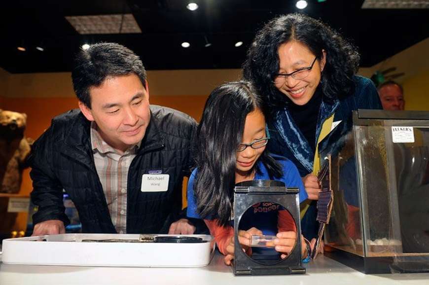 A family looks at a specimen