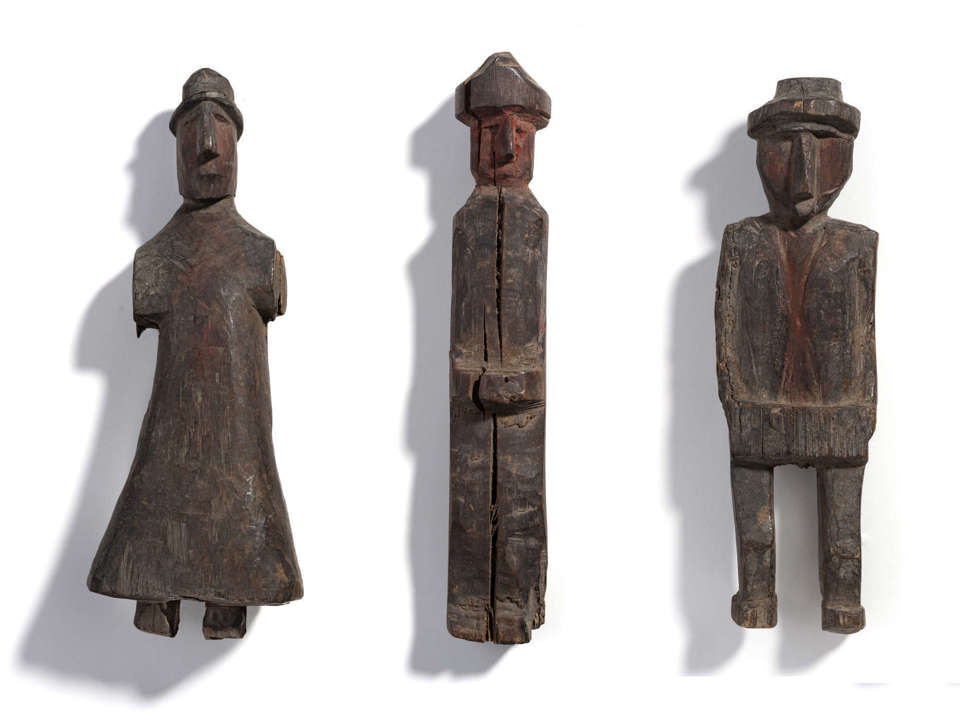 three wooden carved figures from Panama on a white background