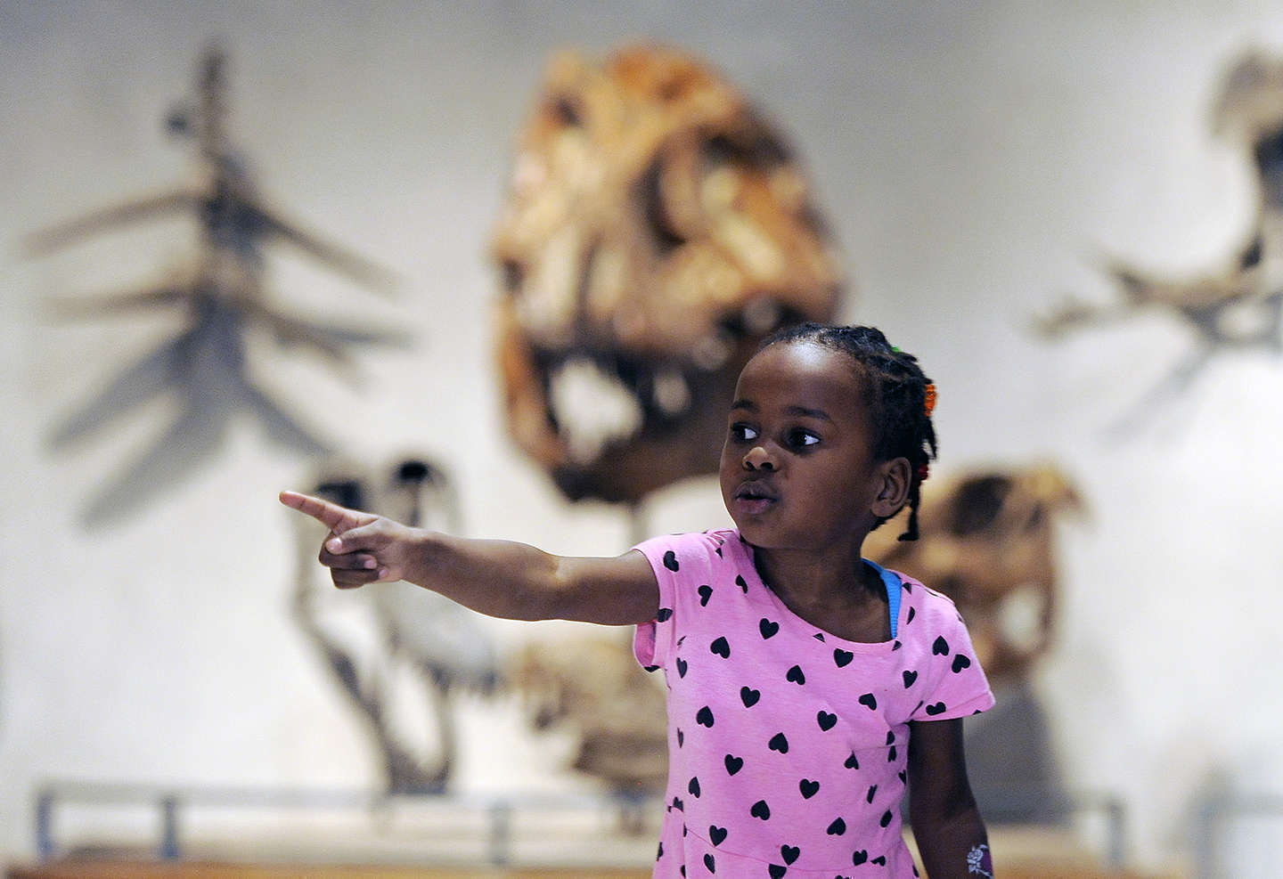 A little girl points into the distance 